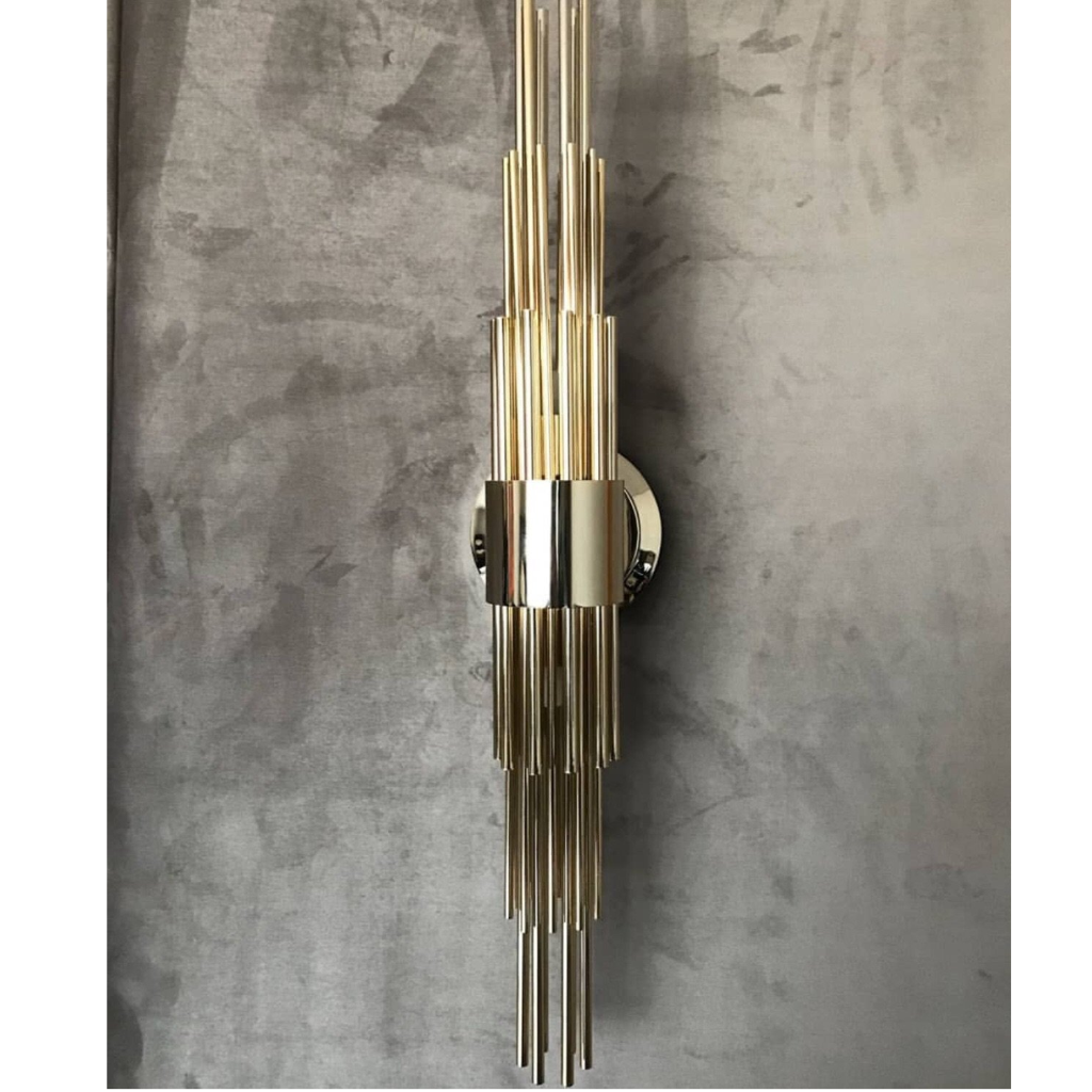 sophisticated elegant art-deco wall light, with sleek lines and shining gold plated finish brass, noble materials, in geometric forms
