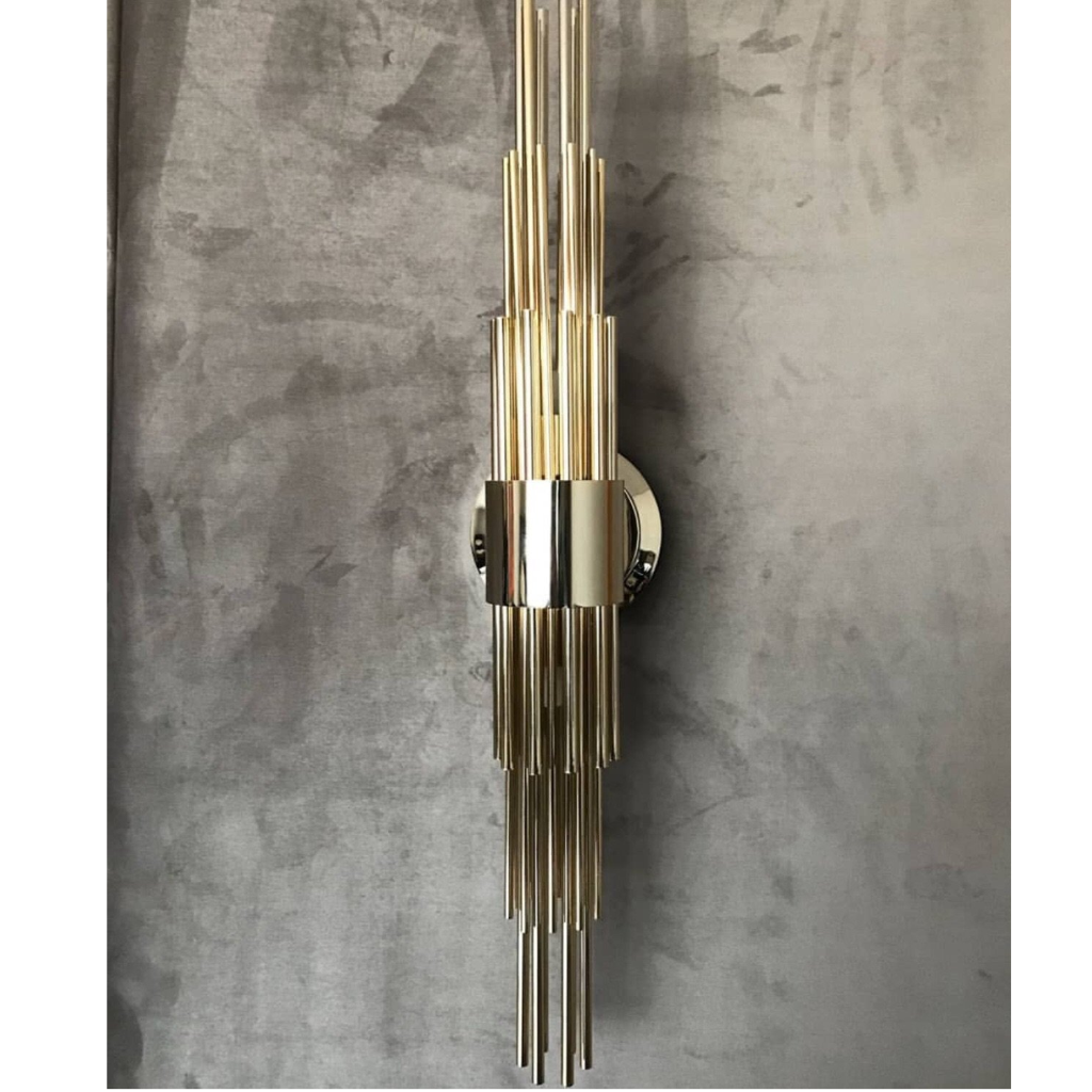 sophisticated elegant art-deco wall light, with sleek lines and shining gold plated finish brass, noble materials, in geometric forms 
